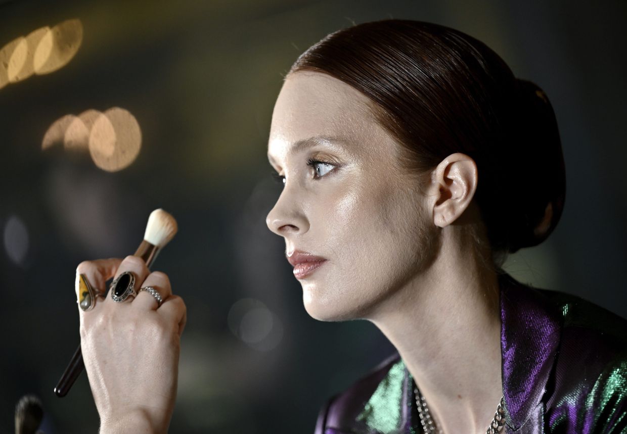 High gloss complexions as seen on a model getting makeup applied backstage at the Christian Siriano Autumn/Winter 2024 fashion show. Photo: AP