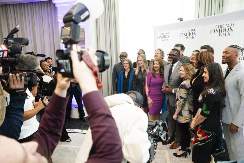 Mayor Brandon Johnson takes a photo with those involved in organizing Chicago Fashion Week.