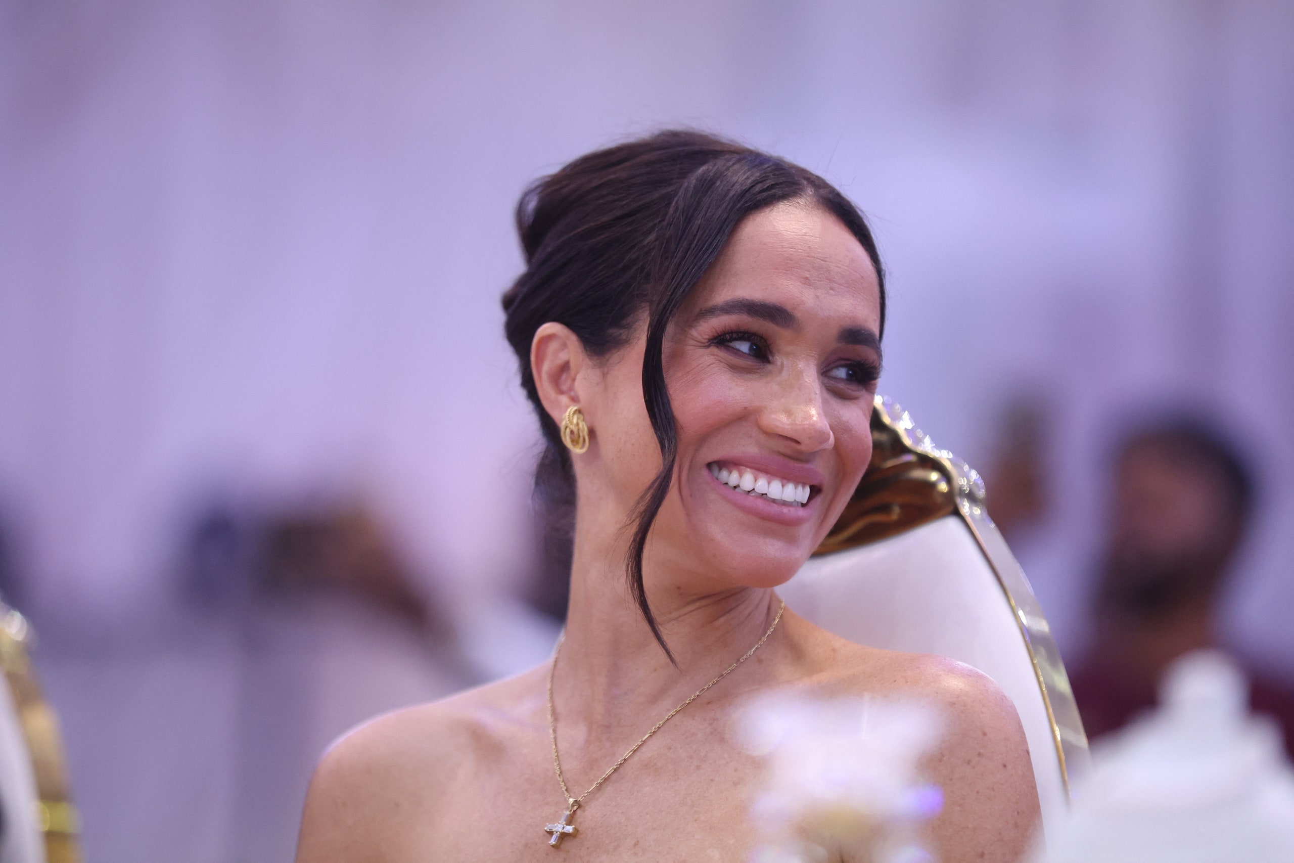 Image may contain Meghan Duchess of Sussex Face Happy Head Person Smile Accessories Jewelry Necklace and Adult