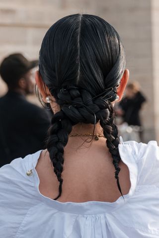 Black haired woman with knotted plaits GettyImages-2045331567