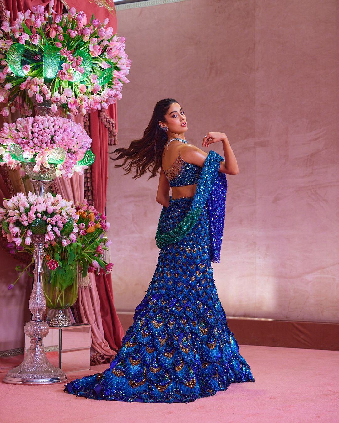 These memories inspired her attire, starting with a peacock-colored lehenga that evolved into a skirt adorned with peacock feathers.