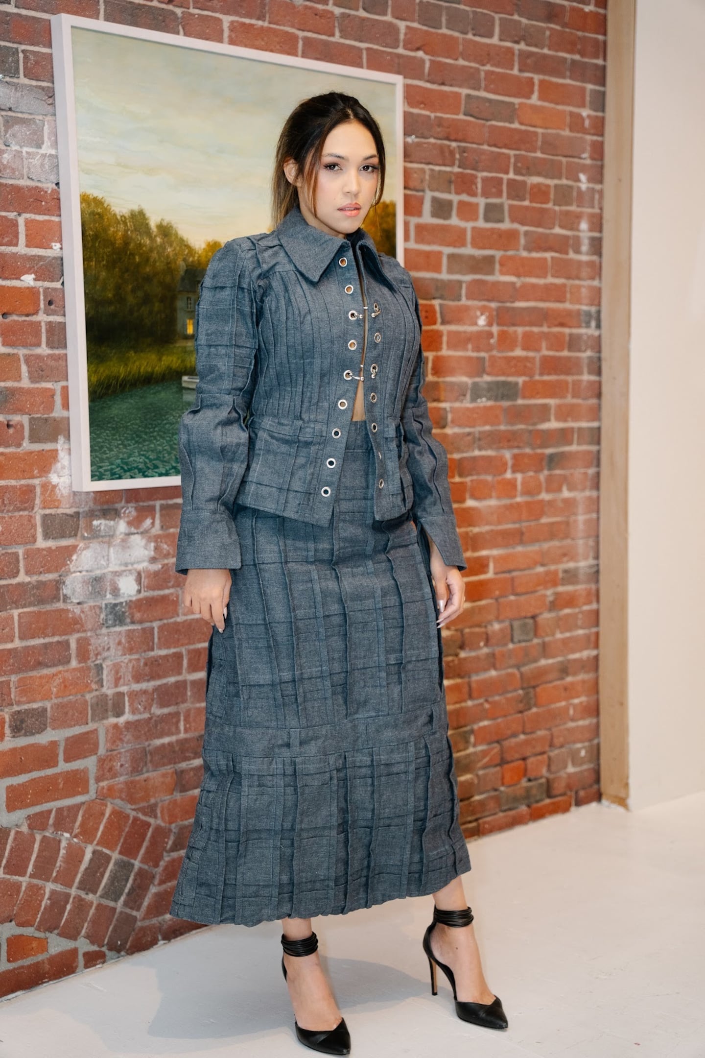 Kyoung Kim uses denim squares on a long skirt to imitate the windows of NYC skyscrapers, with pleating enforcing the rigidness.